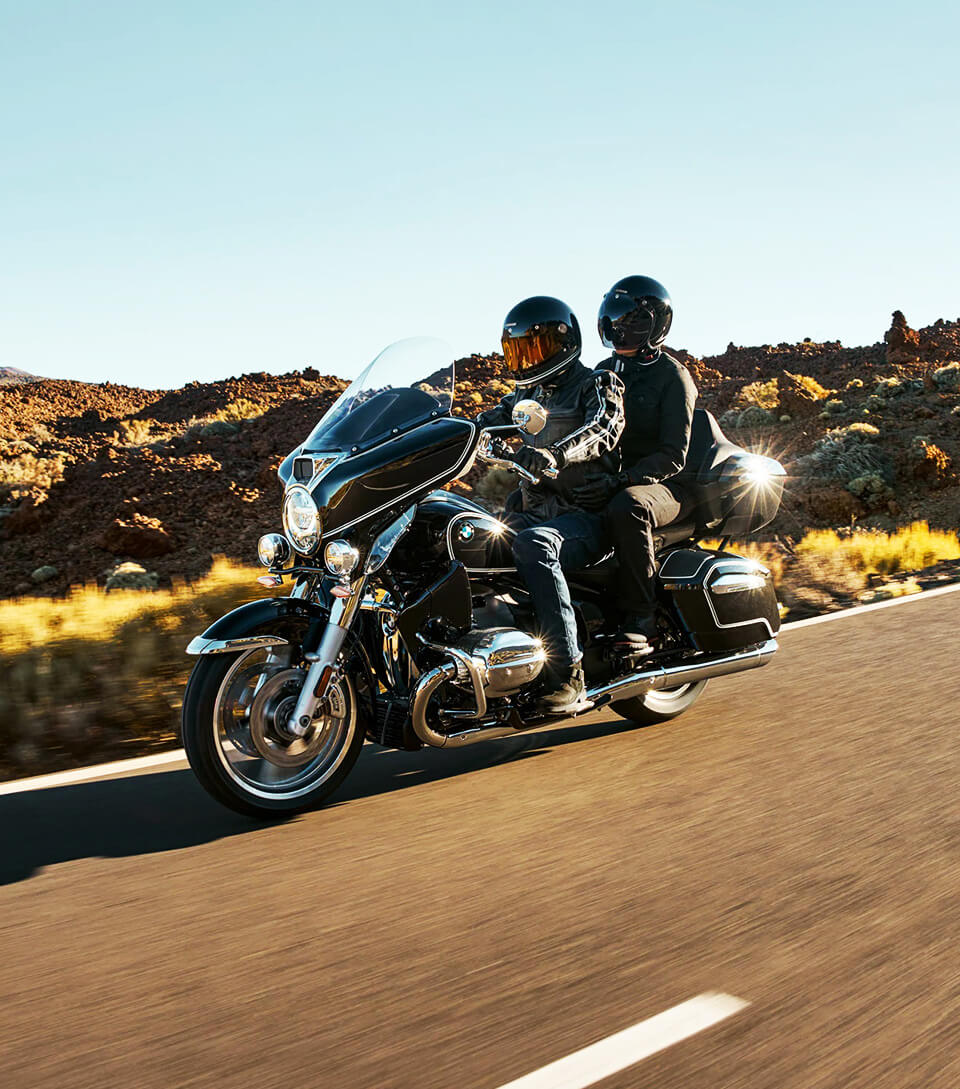 Two people riding on a motorcycle.